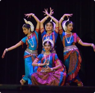 Odissi dancers captivating the audience in a historic venue