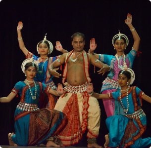 An Odissi dance teacher performing with student's pose