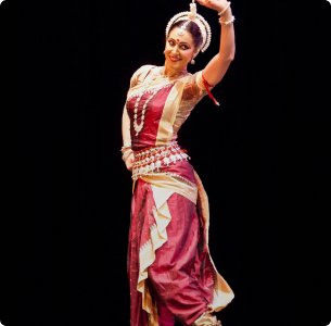 A young Odissi dancer in traditional attire